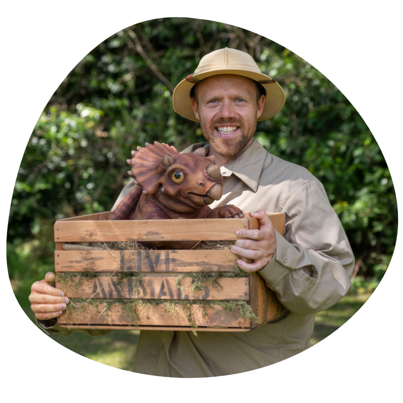 safari ranger with a baby dinosaur at west midlands safari park